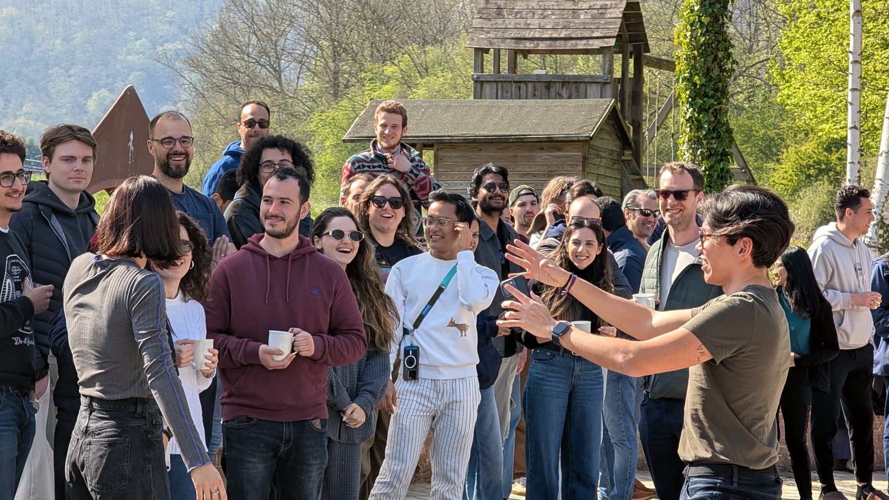 Arthur Chiba running a session with a large group outdoors